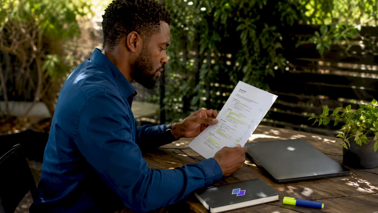 Hands reviewing resume for ATS keywords