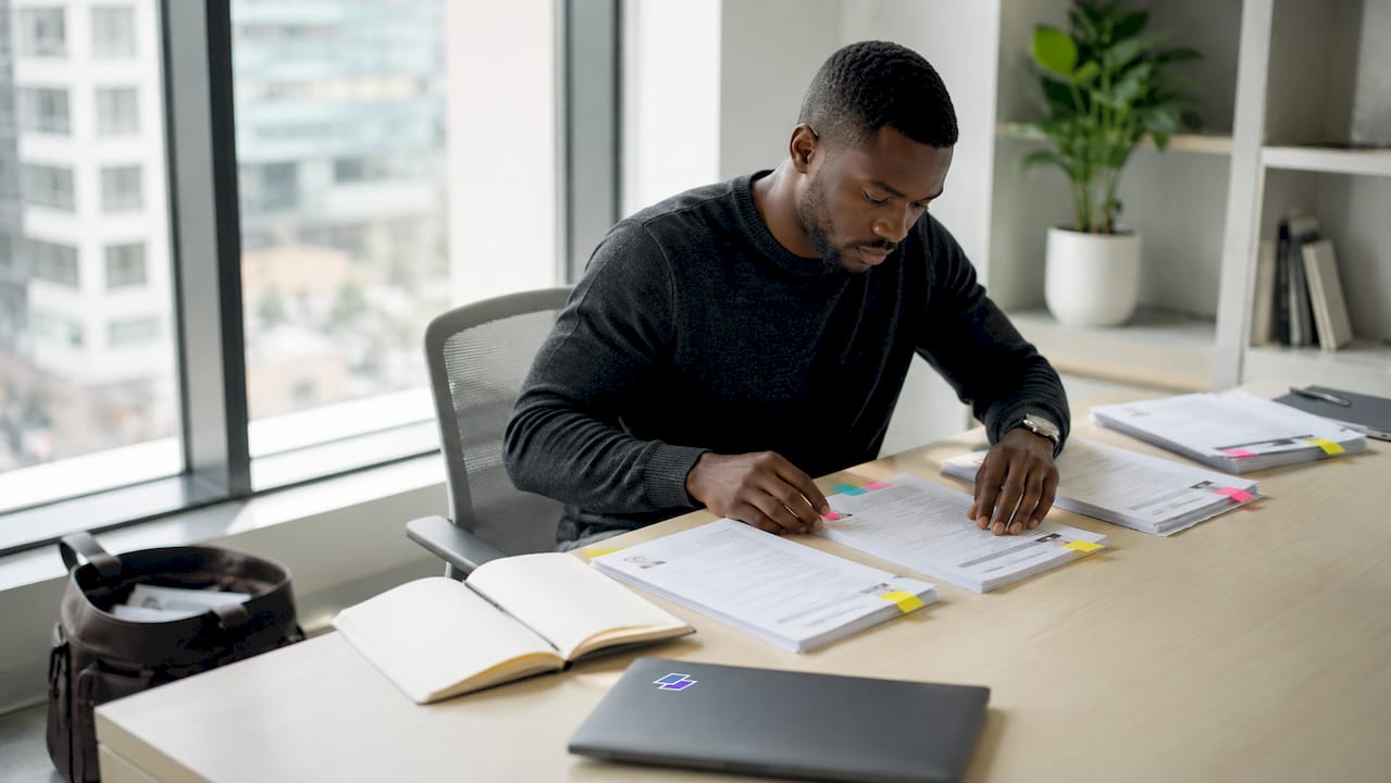 Hands sorting resumes in office setting